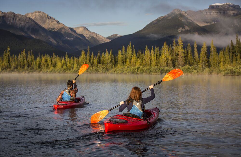 Two people kayaking on Vermilion Lakes in Banff National Park